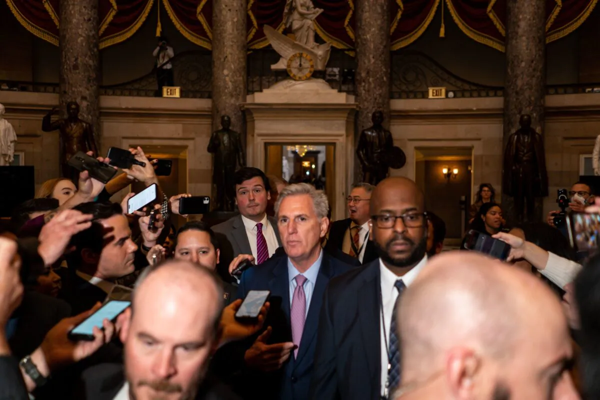 Rep. Kevin McCarthy (R-Calif.) stops to talk to reporters as he walks through National Statuary Hall from the office normally occupied by the speaker of the House, towards the House Chamber at the U.S. Capitol Building in Washington on Jan. 6, 2023. (Kent Nishimura/Los Angeles Time)
