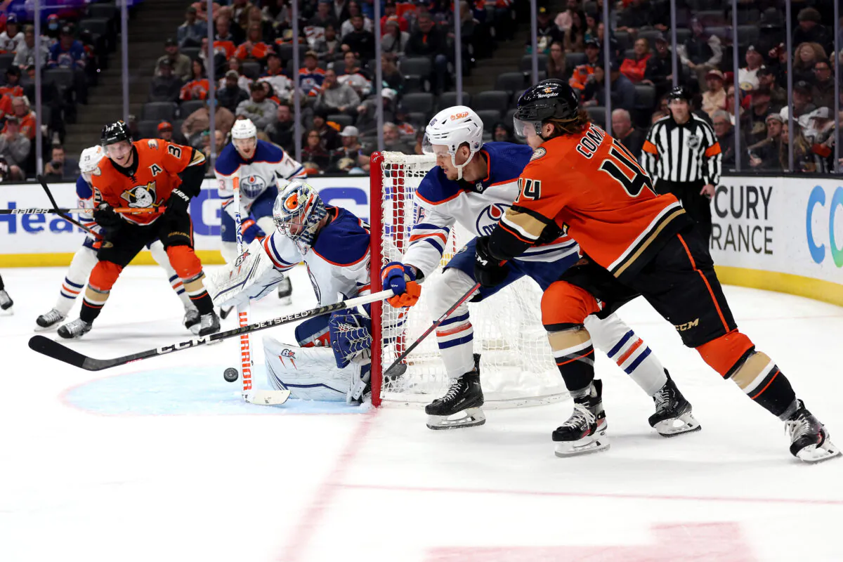 Max Comtois (44) and Jakob Silfverberg (33) of the Anaheim Ducks skate to a loose puck as Philip Broberg (86) and Jack Campbell (36) of the Edmonton Oilers defend during the second period of a game at Honda Center in Anaheim, Calif., on Jan. 11, 2023. (Sean M. Haffey/Getty Images)
