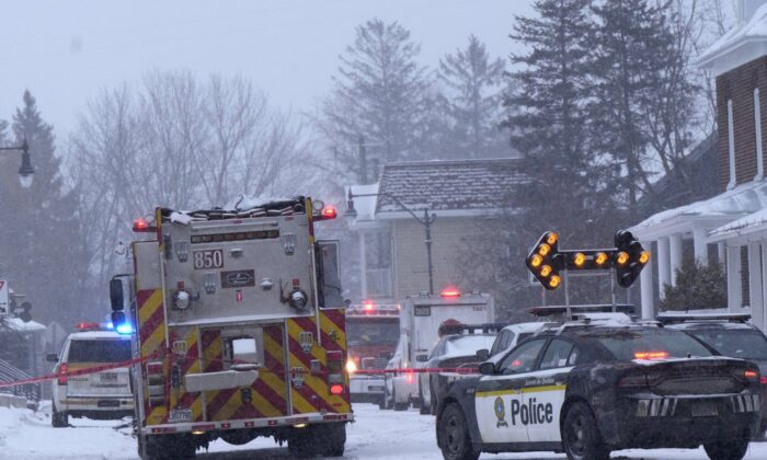 Police and fire officials block off a road as police say at least one worker is missing after an explosion at a propane facility in St-Roch-de-l'Achigan, Que. Jan.12, 2023. (The Canadian Press/Ryan Remiorz)
