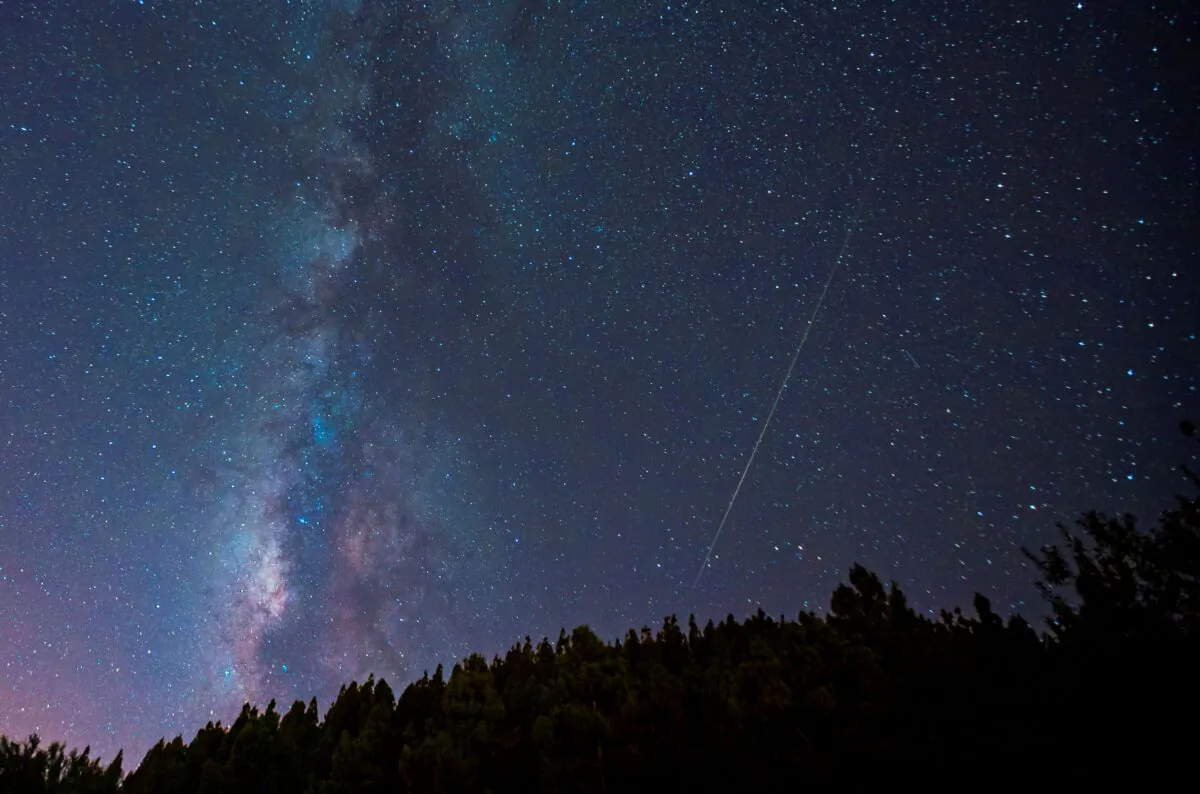 A meteor is photographed near the Milky Way during the annual Perseid meteor shower in Pico de las Nieves, on the island of Gran Canaria, Spain, on Aug. 13, 2021. (Borja Suarez/Reuters)