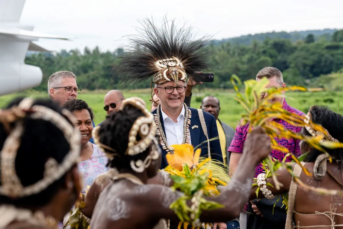 A supplied image obtained on Friday, January 13, 2023, shows Australian Prime Minister Anthony Albanese wearing a traditional headdress during a welcome ceremony in Wewak, Papua New Guinea. Mr Albanese is the first Australian leader to visit the country since 2018. (AAP Image/Supplied by the Prime Minister's Office)