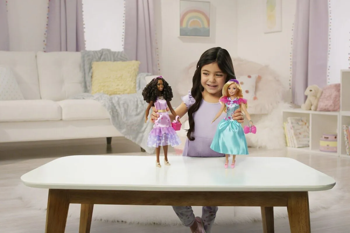 A child plays with Teresa, a My First Barbie deluxe set, new dolls made specifically for children as young as 3. (Mattel via AP)