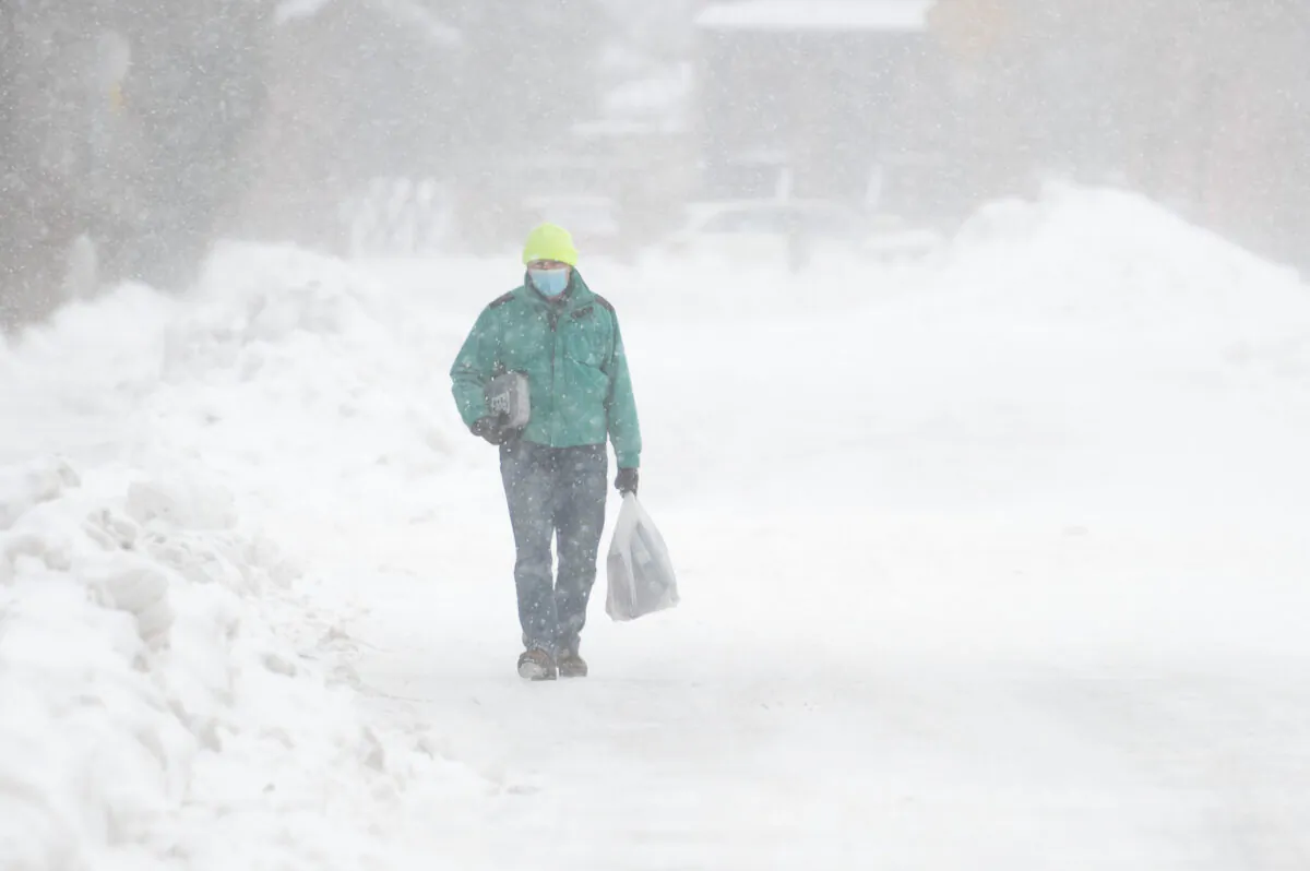 A person makes their way through the Glebe neighbourhood of Ottawa, on Dec. 24, 2022. (Spencer Colby/The Canadian Press)