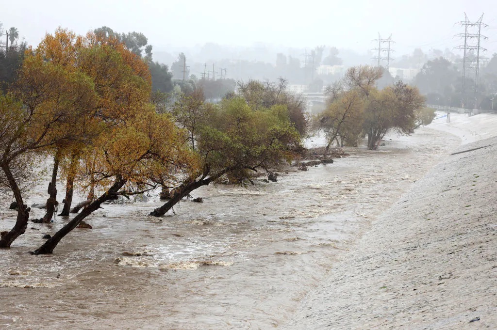 Rain falls as the Los Angeles River flows at a strong rate in Los Angeles on Jan. 9, 2023. (Mario Tama/Getty Images)