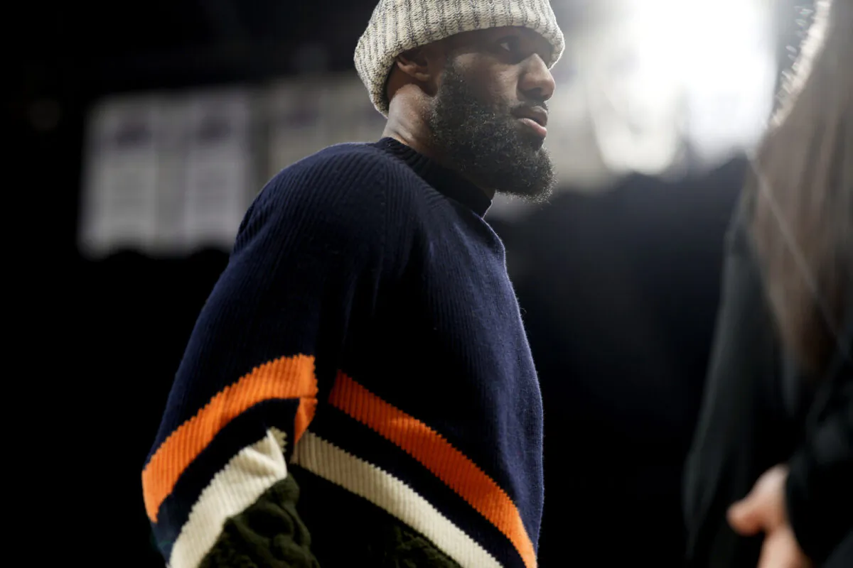 Sidelined for the game by ankle soreness, Los Angeles Lakers forward LeBron James heads to the bench in the second half of an NBA basketball game against the Denver Nuggets in Denver on Jan. 9, 2023. (David Zalubowski/AP Photo)
