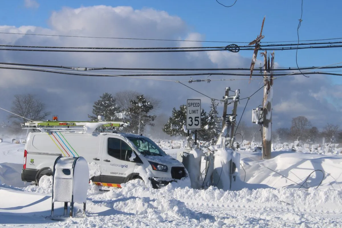 A vehicle from the National Grid near the downed wires of an electric power pole, following a winter storm that struck the region, in Buffalo, N.Y., on Dec. 25, 2022. (Jason Murawski Jr/Instagram/via Reuters)