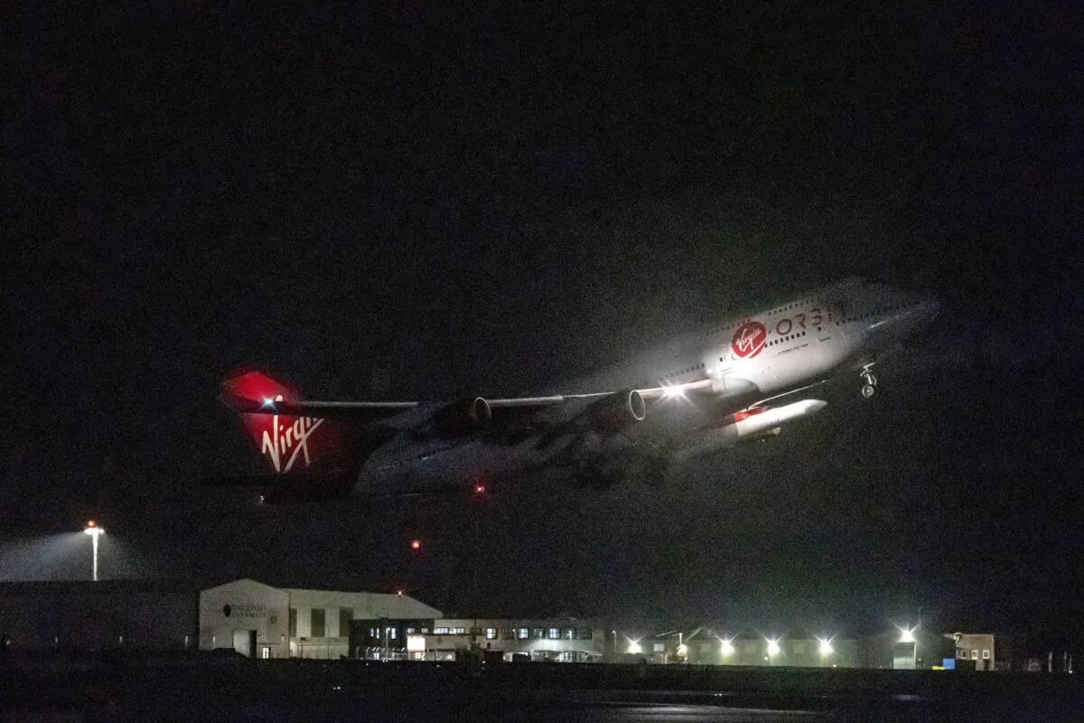 A repurposed Virgin Atlantic Boeing 747 aircraft, named Cosmic Girl, carrying Virgin Orbit's LauncherOne rocket, takes off from Spaceport Cornwall at Cornwall Airport, Newquay, England, on Jan. 9, 2023. (Ben Birchall/PA via AP)