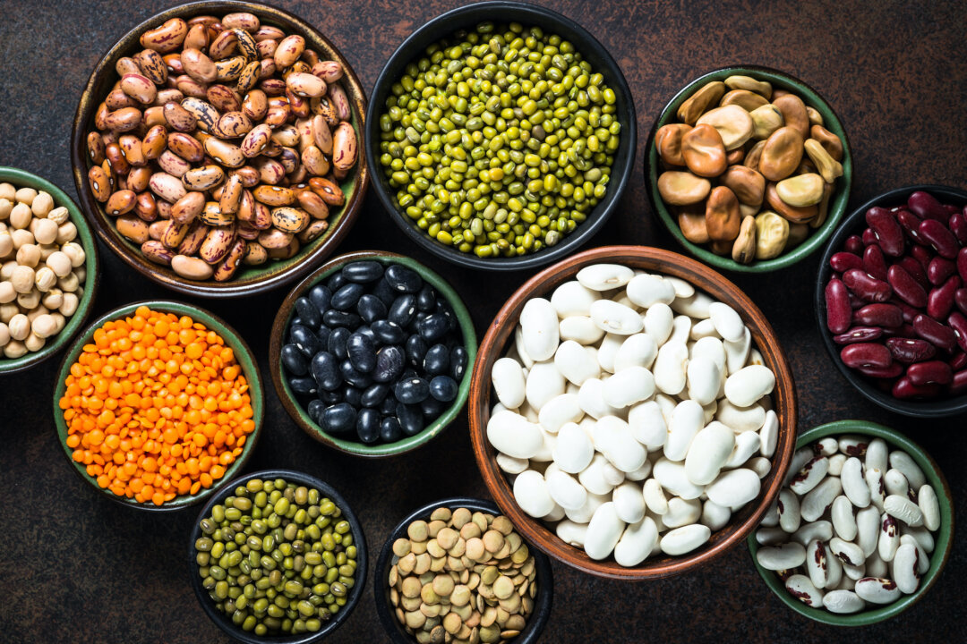 Legumes, lentils, chickpea and beans assortment in different bowls on a stone table. (Shutterstock)