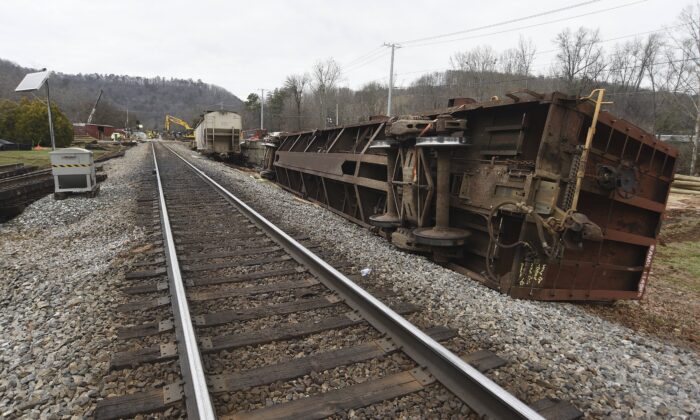 Overturned train cars rest along the tracks at the site of the train derailment at the intersection of the tracks with Apison Pike, Tenn., on Dec. 21, 2022. (Matt Hamilton/Chattanooga Times Free Press via AP)