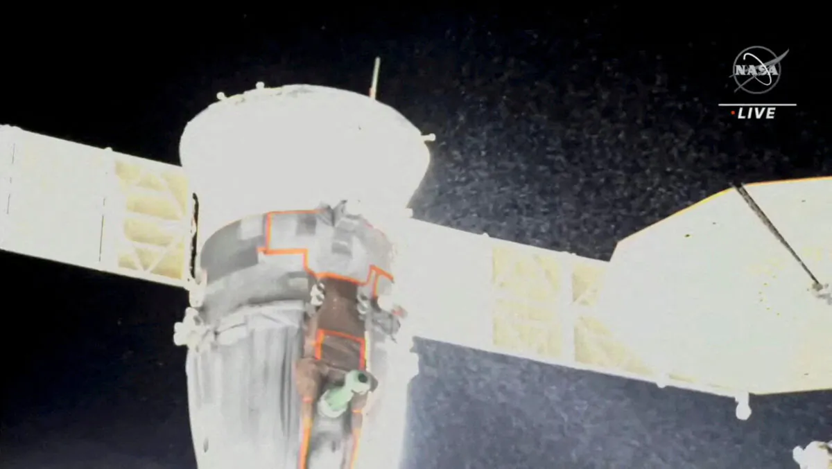 A stream of particles, which NASA says appears to be liquid and possibly coolant, sprays out of the Soyuz spacecraft on the International Space Station, forcing a delay of a routine planned spacewalk by two Russian cosmonauts, in this still image taken from video on Dec. 14, 2022. (NASA TV/Handout via Reuters)