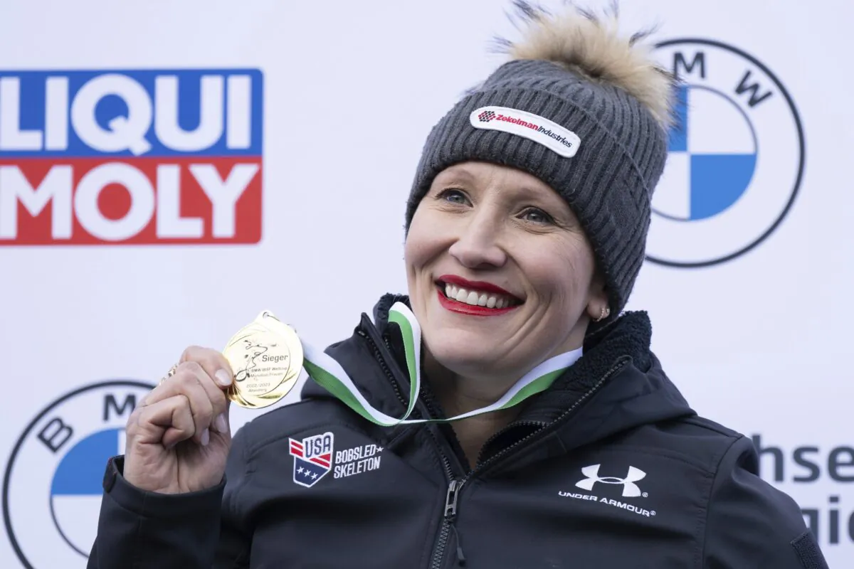 First placed Kaillie Humphries from the United States stands on the podium during the award ceremony  for the women's monobob Bobsleigh World Cup race in Altenberg, Germany, on Jan. 14, 2023. (Sebastian Kahnert/dpa via AP)