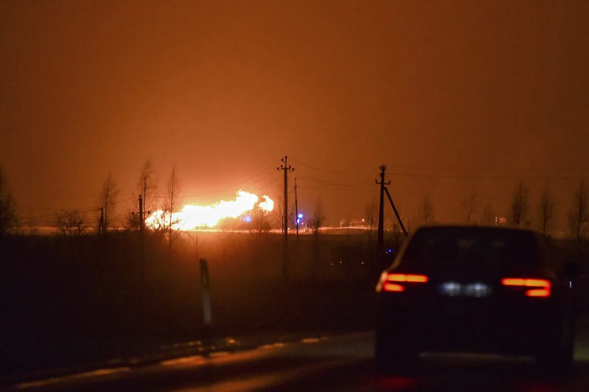 A flame rises after an explosion at a gas pipeline near Pasvalys, 175 km (109 miles) north of Vilnius in northern Lithuania on Friday, Jan. 13, 2023. Officials say an explosion has occurred in a pipeline in central Lithuania carrying natural gas to the north of the country and neighboring Latvia but no supply disruptions or injuries were reported. Baltic media reported that Friday's blast sent flames up to 50 meters (164 feet) into the sky and forced the protective evacuation of a nearby village. (AP Photo/Paulius Zidonis)