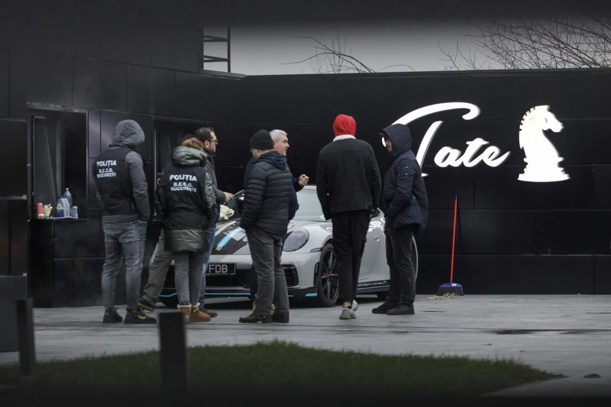 Romanian officials transport the cars seized from Andrew Tate's compound to a storage location in Pipera, Ilfov, Romania, on Jan. 14, 2023. (Inquam Photos/Octav Ganea via Reuters)