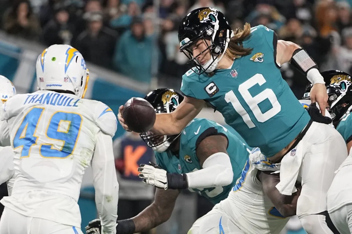 Jacksonville Jaguars quarterback Trevor Lawrence (16) leaps for a two-point conversion against the Los Angeles Chargers during the second half of an NFL wild-card football game in Jacksonville, Fla., on Jan. 14, 2023. (Chris Carlson/AP Photo)