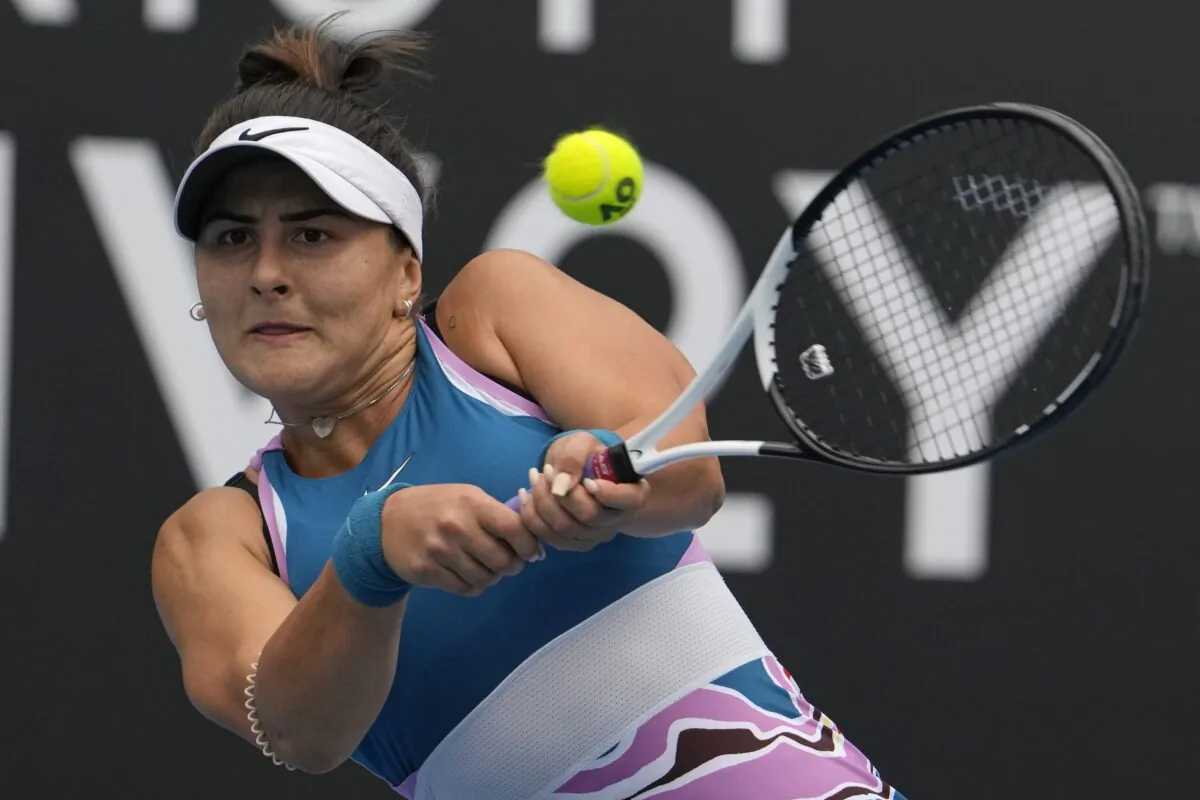 Bianca Andreescu of Canada plays a backhand return to Marie Bouzkova of the Czech Republic during their first round match at the Australian Open tennis championship in Melbourne, Australia, on Jan. 16, 2023. (Ng Han Guan/AP Photo)