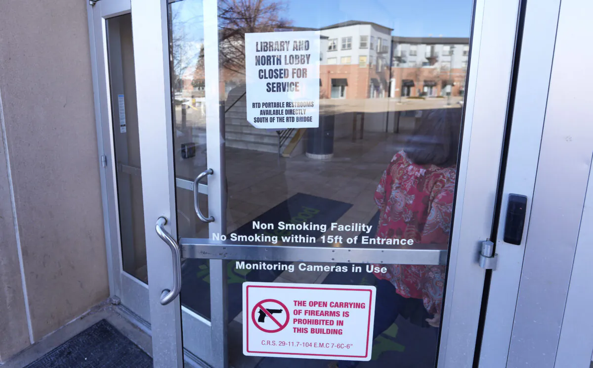 Signs outside doors of city hall to advise visitors that the library as well as a restroom are closed because of meth contamination in the south Denver suburb of Englewood, Colo., on Jan. 12, 2022. (David Zalubowski/AP Photo)