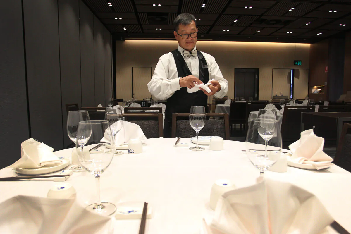 A restaurant waiter prepares tables at a Chinese restaurant in Sydney, Australia, on March 5, 2020. (Lisa Maree Williams/Getty Images)