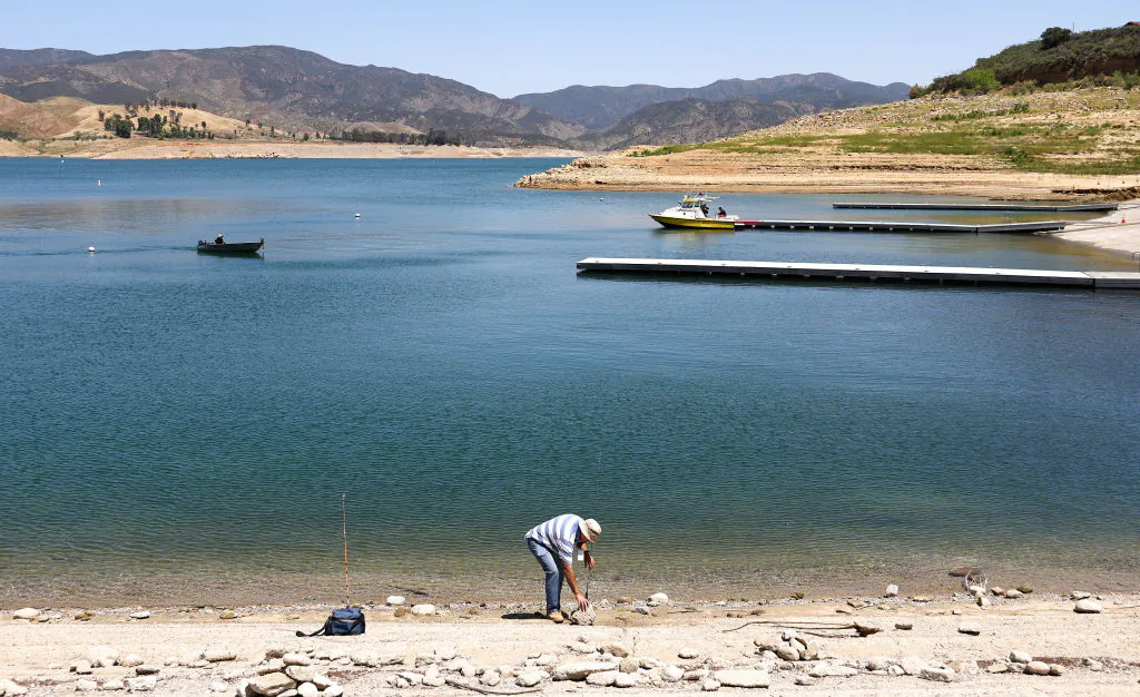 A person fishes along the dam at the Castaic Lake reservoir in Castaic, Calif., on May 3, 2022. (Mario Tama/Getty Images)