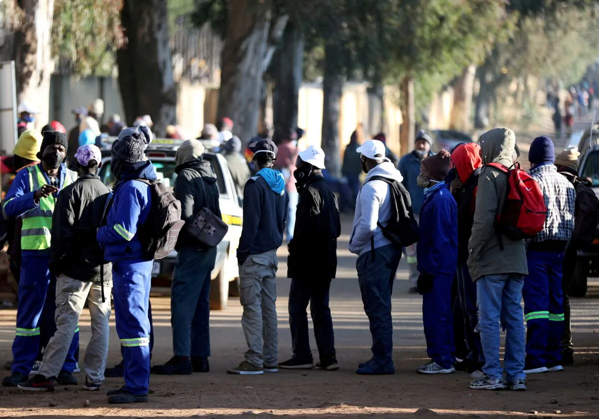 Job seekers stand outside a construction site in Eikenhof, south of Johannesburg, South Africa, on June 23, 2020. (Siphiwe Sibeko/Reuters)