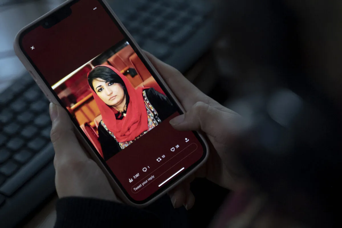 A woman looks at a picture of former Afghan lawmaker Mursal Nabizada on her mobile phone, who was shot dead by gunmen at her house in Kabul on Jan. 15, 2023. Mursal Nabizada had been a member of parliament in the previous Western-backed regime who had turned down the opportunity to flee Afghanistan when the Taliban seized power in August 2021. (WAKIL KOHSAR/AFP via Getty Images)