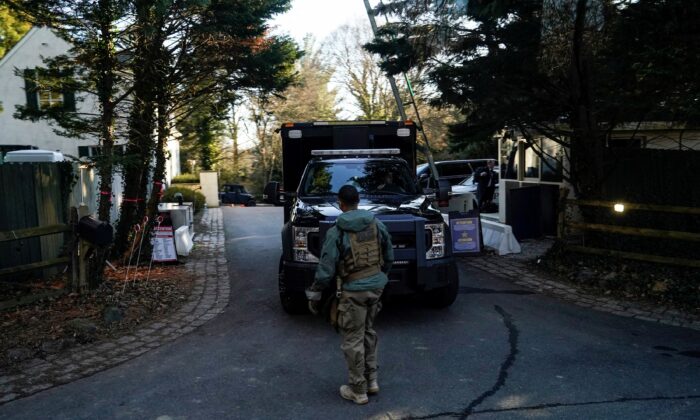 Secret Service personnel park vehicles in the driveway leading to President Joe Biden's house after classified documents were found there by Biden's lawyers, in Wilmington, Del., on Jan. 15, 2023. (Joshua Roberts/Reuters)