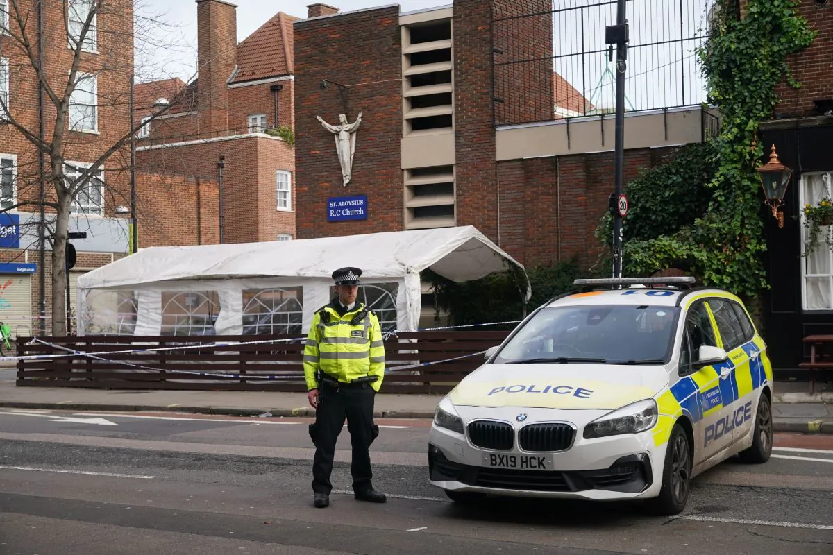 A police officer guards the scene of a shooting outside St. Aloysius Roman Catholic Church in Euston, central London, on Jan. 15, 2023. (PA)