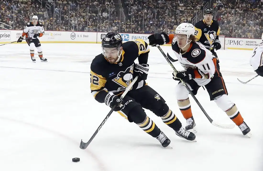 Pittsburgh Penguins defenseman Mark Friedman (52) moves the puck ahead of Anaheim Ducks center Trevor Zegras (11) during the first period  at PPG Paints Arena in Pittsburgh on Jan. 16, 2023. (Charles LeClaire/USA TODAY Sports via Field Level Media)
