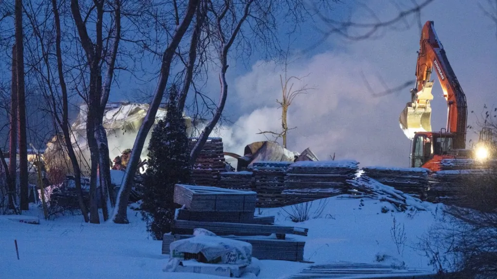 Firefighters work the scene after an explosion at a propane company, Jan. 12, 2023 in Saint-Roch-de-L’Achigan, Que. (The Canadian Press/Ryan Remiorz)