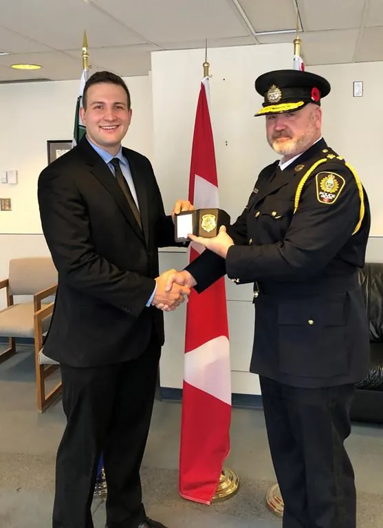 Constable Mathieu Nolet, left, poses with Chief Donovan Fisher during a swearing-in ceremony in Nelson, B.C., in this undated handout photo. (The Canadian Press/HO - City of Nelson)