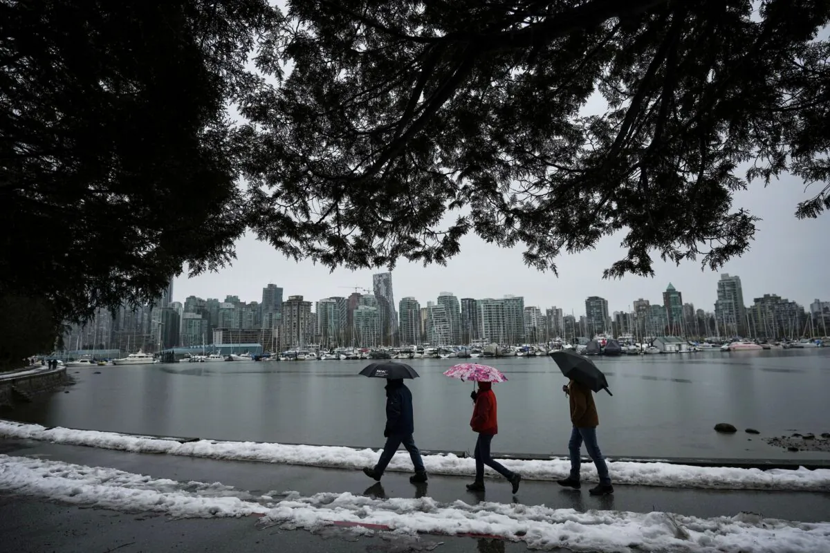 People walk along the Stanley Park seawall in Vancouver on Dec. 25, 2022. (The Canadian Press/Darryl Dyck)