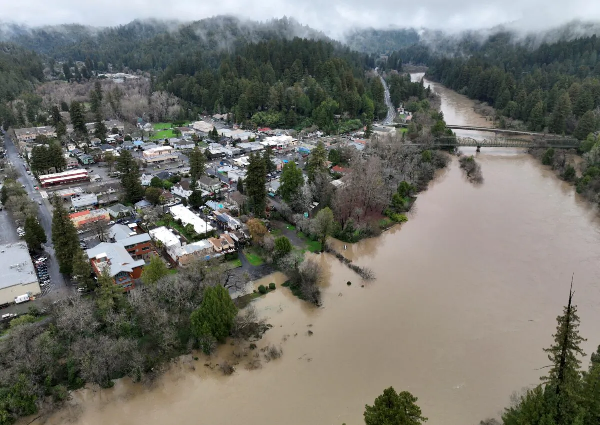 The Russian River, swollen with floodwater following a chain of winter storms, flows past the town of Guerneville, Calif., on Jan. 15, 2023. (Fred Greaves/Reuters)