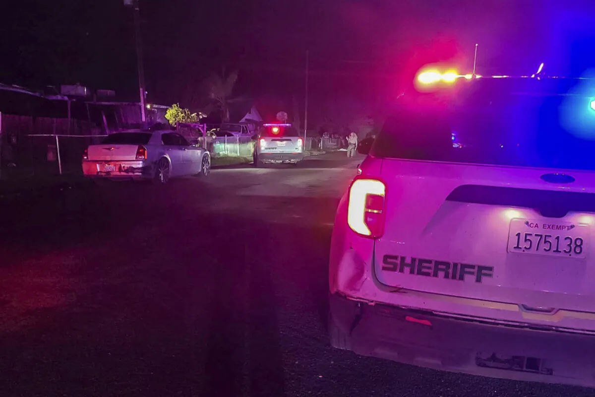 In this image released by Tulare County Sheriff's Office, detectives investigate a shooting in Goshen near Visalia, Calif., on Jan. 16, 2023. (Tulare County Sheriff's Office via AP)