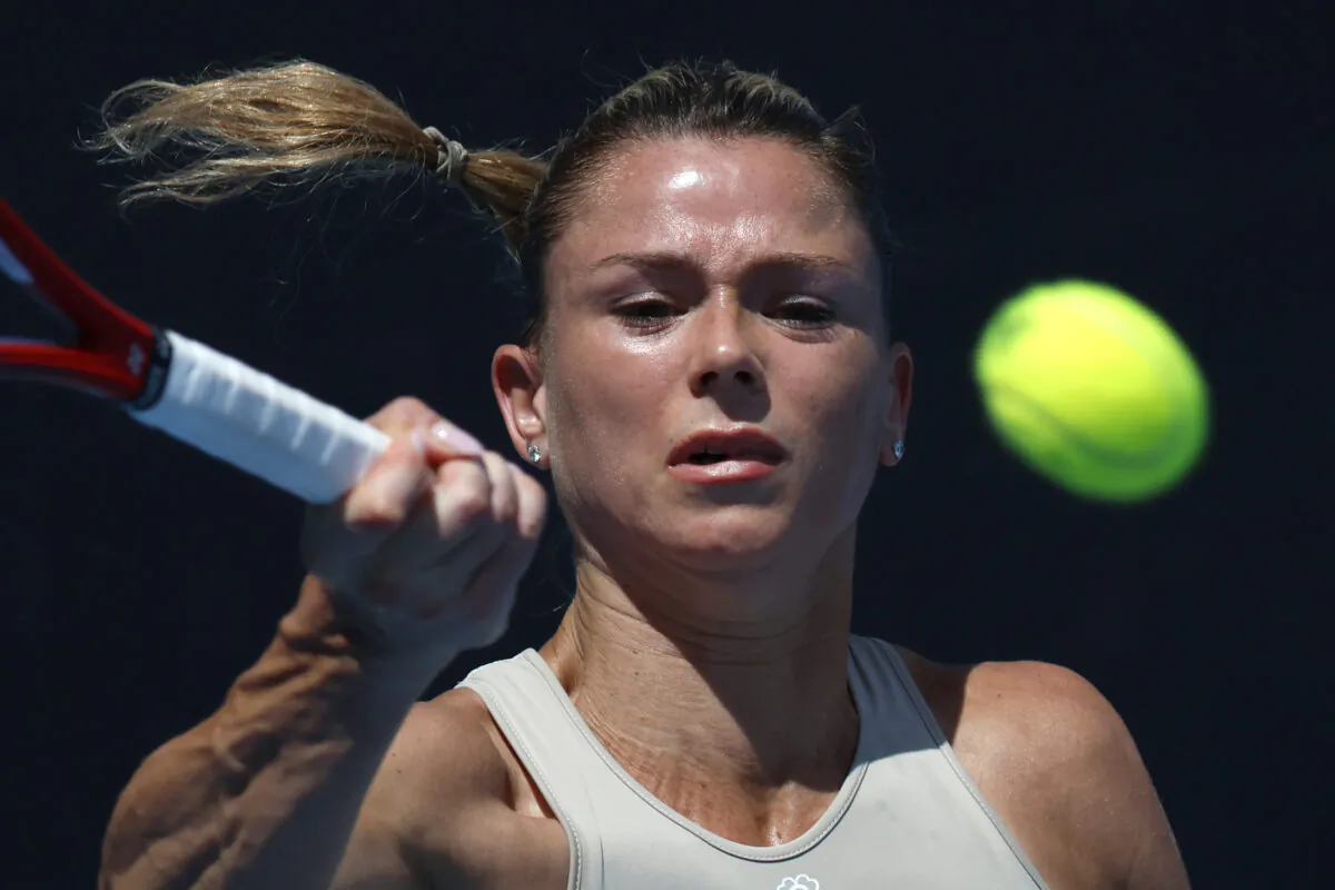 Camila Giorgi of Italy plays a forehand return to Anastasia Pavlyuchenkova of Russia during their first round match at the Australian Open tennis championship in Melbourne, Australia, on Jan. 17, 2023. (Asanka Brendon Ratnayake/AP Photo)