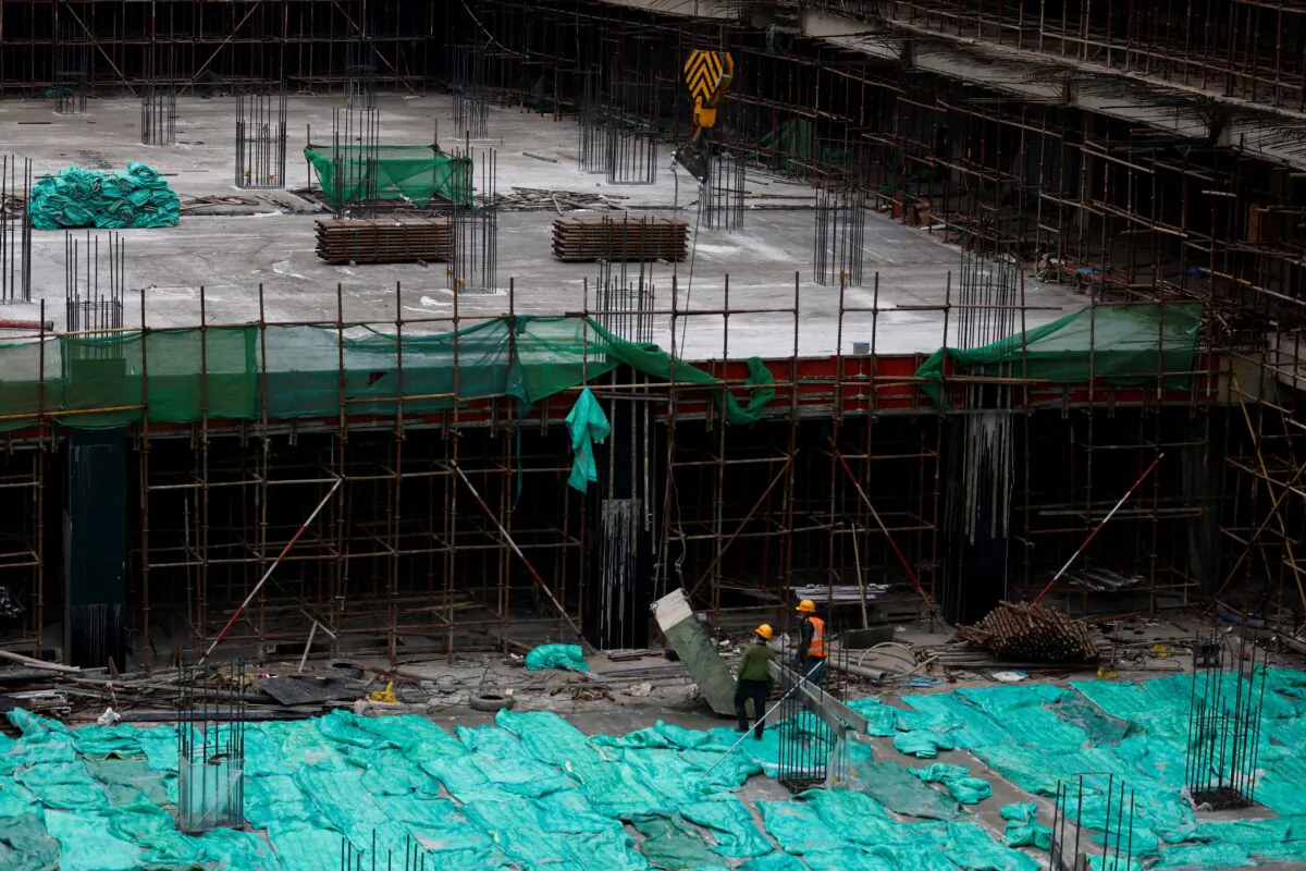 Workers work at a construction site in Beijing on Jan. 12, 2023. (Tingshu Wang/Reuters)