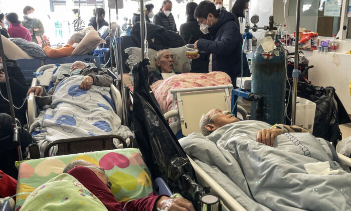 Patients on stretchers are seen at Tongren hospital in Shanghai on January 3, 2023. (Hector Retamal /AFP via Getty Images)