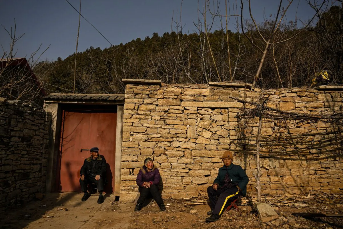 Elderly villagers in front of a house in a rural area in Tai'an, China's eastern Shandong province, on Jan. 7, 2023. (Noel Celis/AFP via Getty Images)