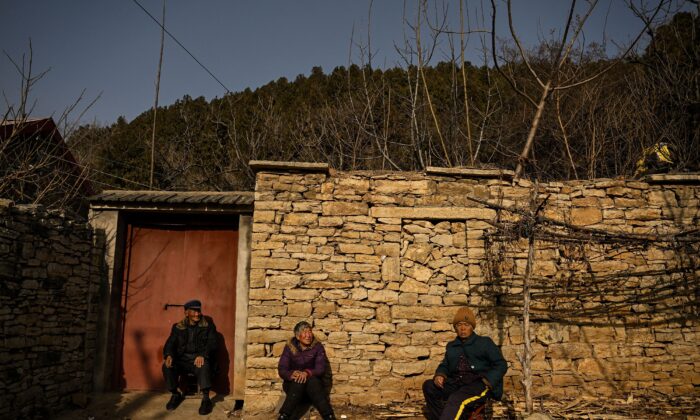 Elderly people sitting in front of a house in a rural area in Tai'an,  Shandong Province. (Noel Celis/AFP via Getty Images)