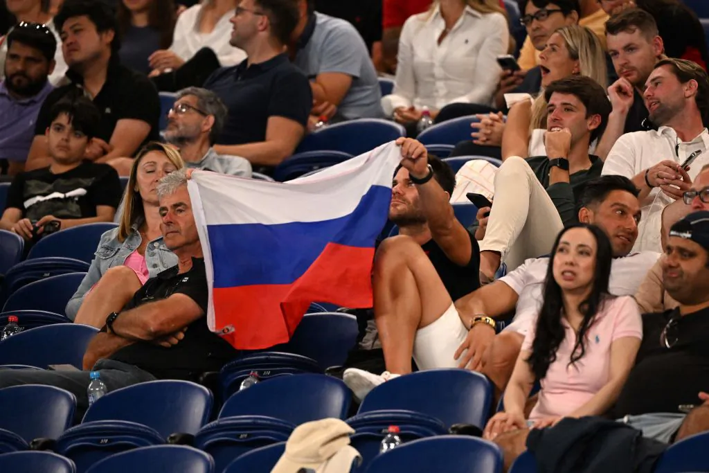 A supporter holds a flag of Russia during the men's singles match between Marcos Giron of the US and Russia's Daniil Medvedev on day one of the Australian Open tennis tournament in Melbourne, Australia on Jan. 16, 2023. (William West/AFP via Getty Images)
