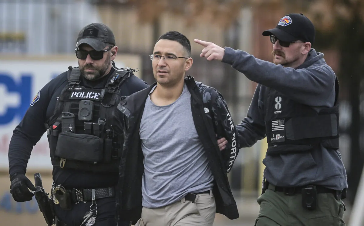 Solomon Pena (C), a Republican candidate for New Mexico House District 14, is taken into custody by Albuquerque Police officers in southwest Albuquerque, N.M., on Jan. 16, 2023. (Roberto E. Rosales/The Albuquerque Journal via AP)