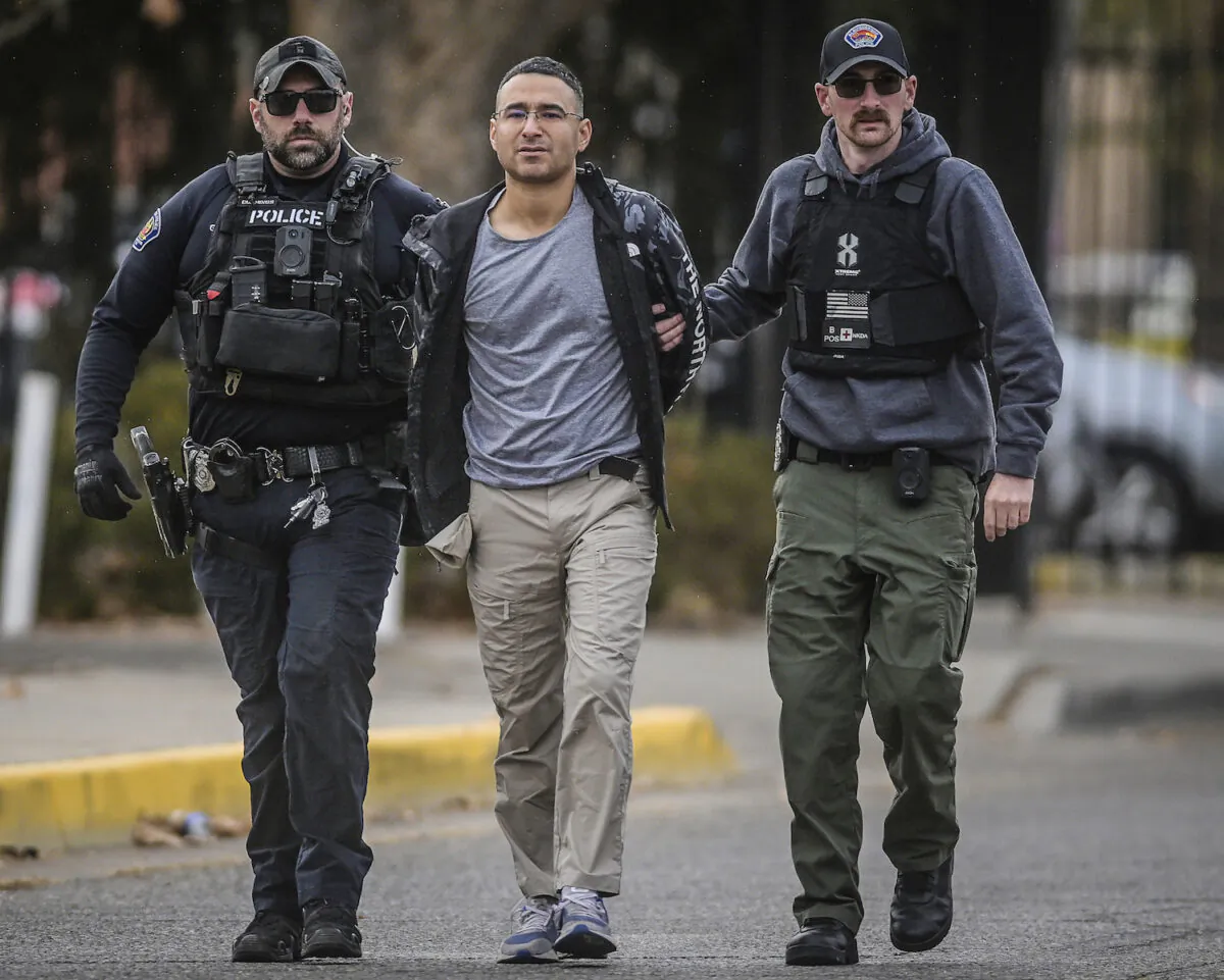 Solomon Pena (C), a Republican candidate for New Mexico House District 14, is taken into custody by Albuquerque Police officers in southwest Albuquerque, N.M., on Jan. 16, 2023. (Roberto E. Rosales/The Albuquerque Journal via AP)