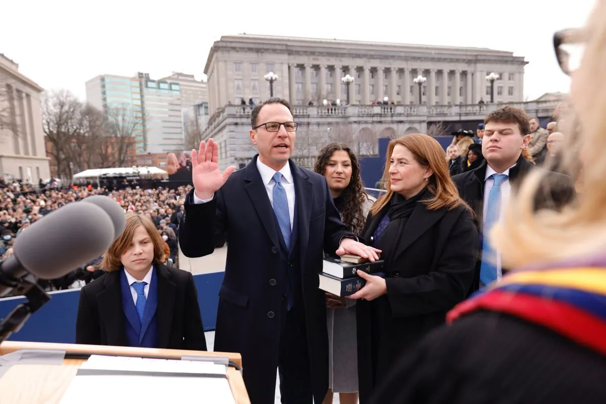 Pennsylvania's 48th governor, Josh Shapiro, is sworn into office. His wife Lori holds a stack of three Bibles as their four children stand in support in Harrisburg, Pa., on Jan. 17, 2023 (Courtesy of Commonwealth Media Services)