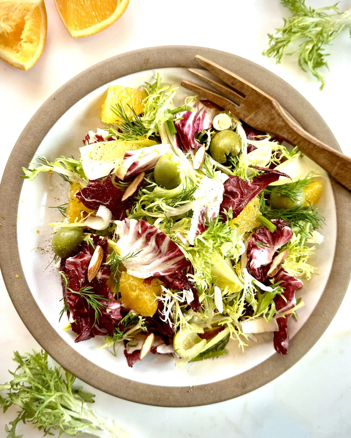 Crunchy nuts, puckery fruit, briny olives, and sharp onions are excellent team players in a chicory salad. (Lynda Balslev for Tastefood)