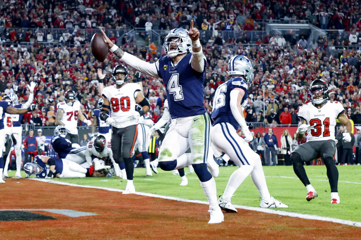 Dak Prescott (4) of the Dallas Cowboys rushes for a touchdown against the Tampa Bay Buccaneers during the second quarter in the NFC Wild Card playoff game at Raymond James Stadium in Tampa on Jan. 16, 2023. (Mike Ehrmann/Getty Images)