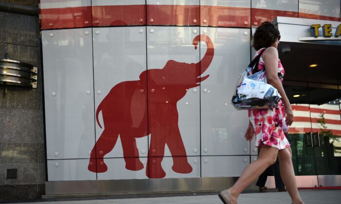 A woman walks past the elephant logo of the Republican Party on the first day of the Republican National Convention in Cleveland on July 18, 2016. (Dominick Reuter/AFP via Getty Images)