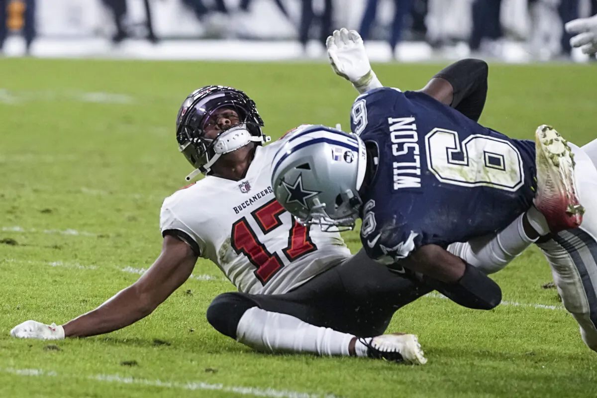 Tampa Bay Buccaneers wide receiver Russell Gage (17) is hit Dallas Cowboys safety Donovan Wilson (6) during the second half of an NFL wild card football game, in Tampa, Fla., on Jan. 16, 2023. (Chris Carlson/AP Photo)