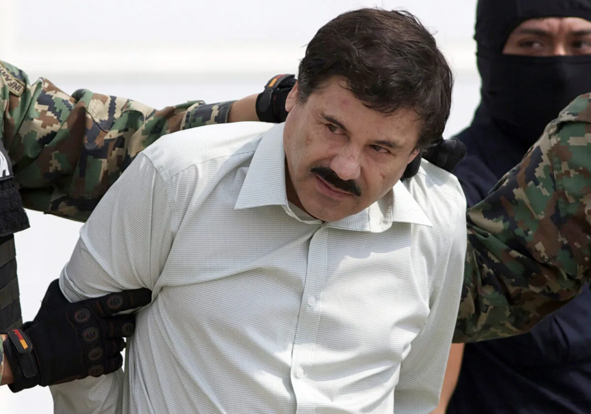 Joaquin "El Chapo" Guzman, the head of Mexico's Sinaloa Cartel, is escorted to a helicopter in Mexico City following his capture in the beach resort town of Mazatlan, Mexico, on Feb. 22, 2014. (Eduardo Verdugo/AP Photo)