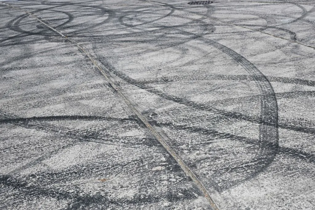 Tire skid marks from drivers doing burnouts and "donuts" on Bellevue Ave near Bob's Market are seen in the Angelino Heights neighborhood of Los Angeles, on Aug. 26, 2022. (Patrick T. Fallon/AFP via Getty Images)