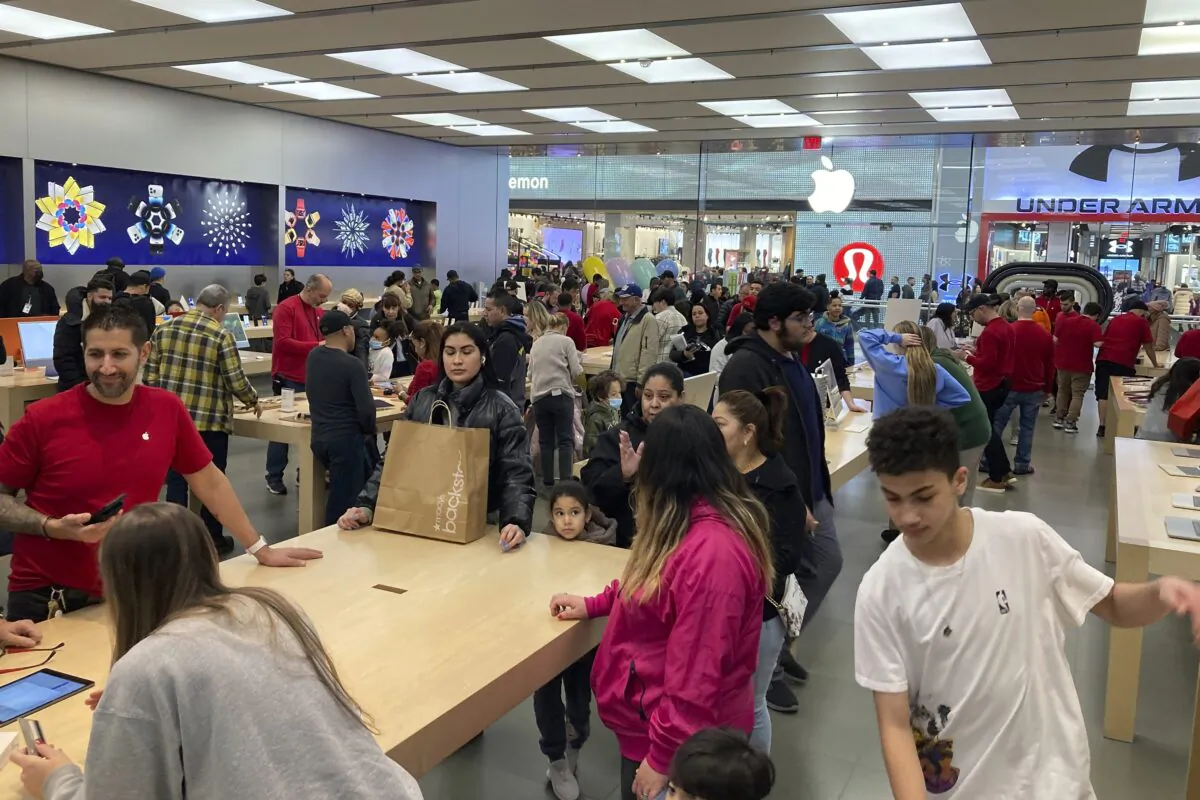 People shop at an Apple store in the Westfield Garden State Plaza mall in Paramus, N.J., on Dec. 17, 2022. (Ted Shaffrey/AP Photo)