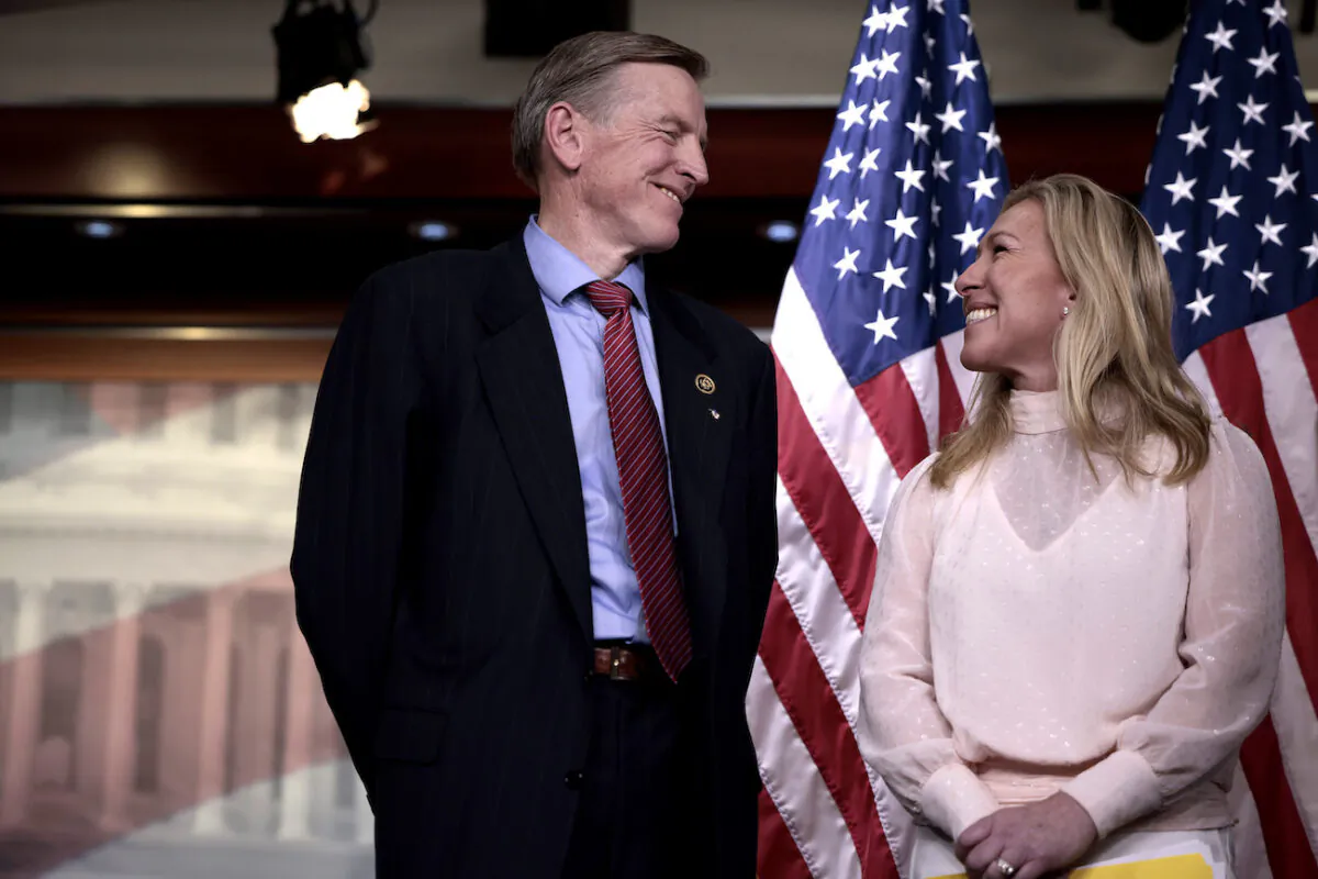 Rep. Marjorie Taylor Greene (R-Ga.) smiles at Rep. Paul Gosar (R-Ariz.) during a news conference at the U.S. Capitol Building in Washington, on Dec. 7, 2021. (Anna Moneymaker/Getty Images)