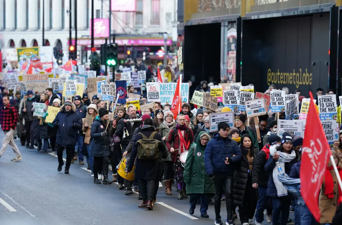 Protesters march through London, towards Downing Street, during the nurses strike, against the Bill on minimum service levels during strikes, on Jan. 18, 2023. (Zac Goodwin/PA Media)